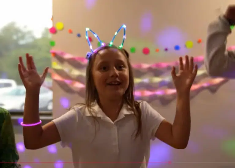 A excited child awaits the balloon drop