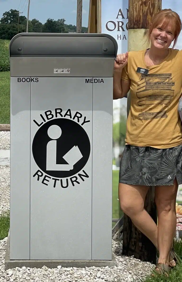 Bookmobile Librarian next to Book Drop at Stull's Country Store